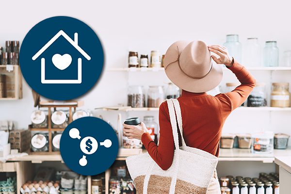 Woman in stylish hat holding a cup of coffee shops for home goods at a trendy local store.