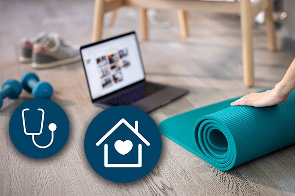 Hands rolling Yoga mat with laptop computer on the ground, weights, and sneakers.