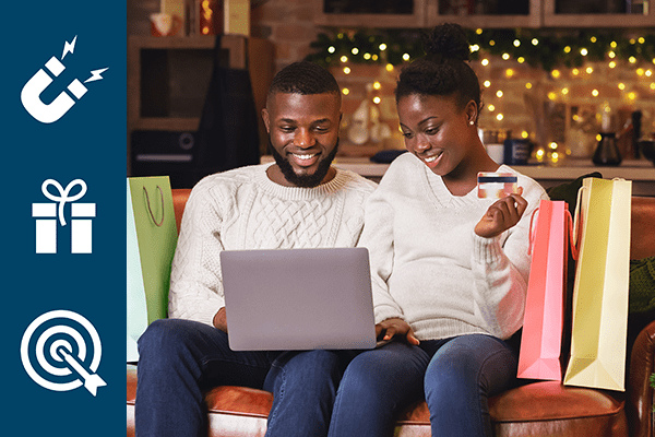 Couple at Christmas time surrounded by bags sitting on couch looking at laptop and holding a debit card with a navy left pane of marketing icons.